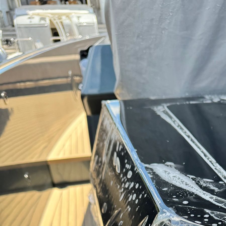 Clear protective film laid over a yacht surface beside a teak deck during installation