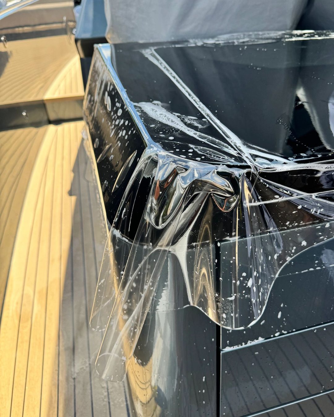 Premier Surface Protection applying clear film to a yacht surface