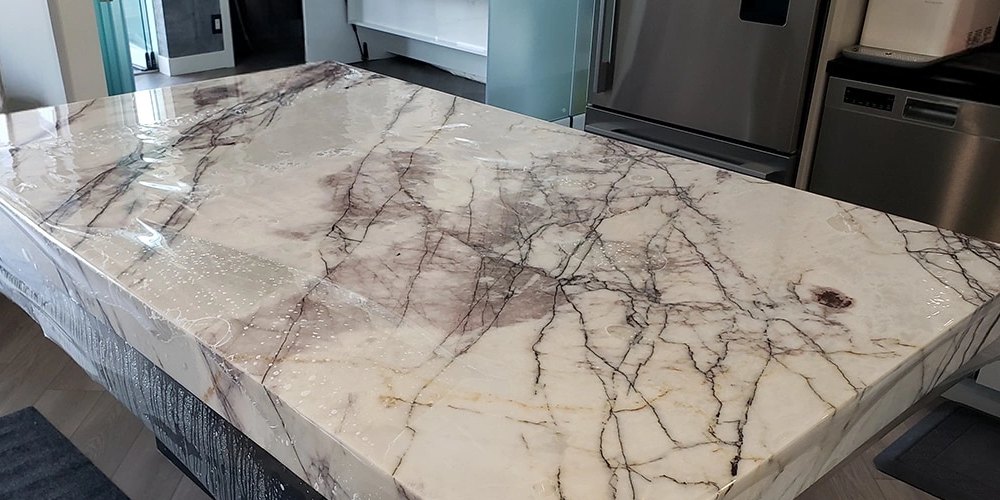 Premier Surface Protection installing countertop surface film on polished stone